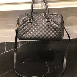 Talbot quilted black leather bag with beige interior and two straps.